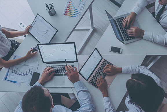 Corporate team at work in office on computers