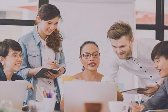 Group of casual business owners looking at computer